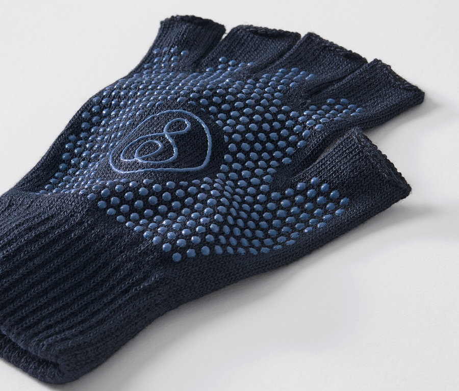 Egy sötétkék jógakesztyű közeli képe csúszásgátlóval.