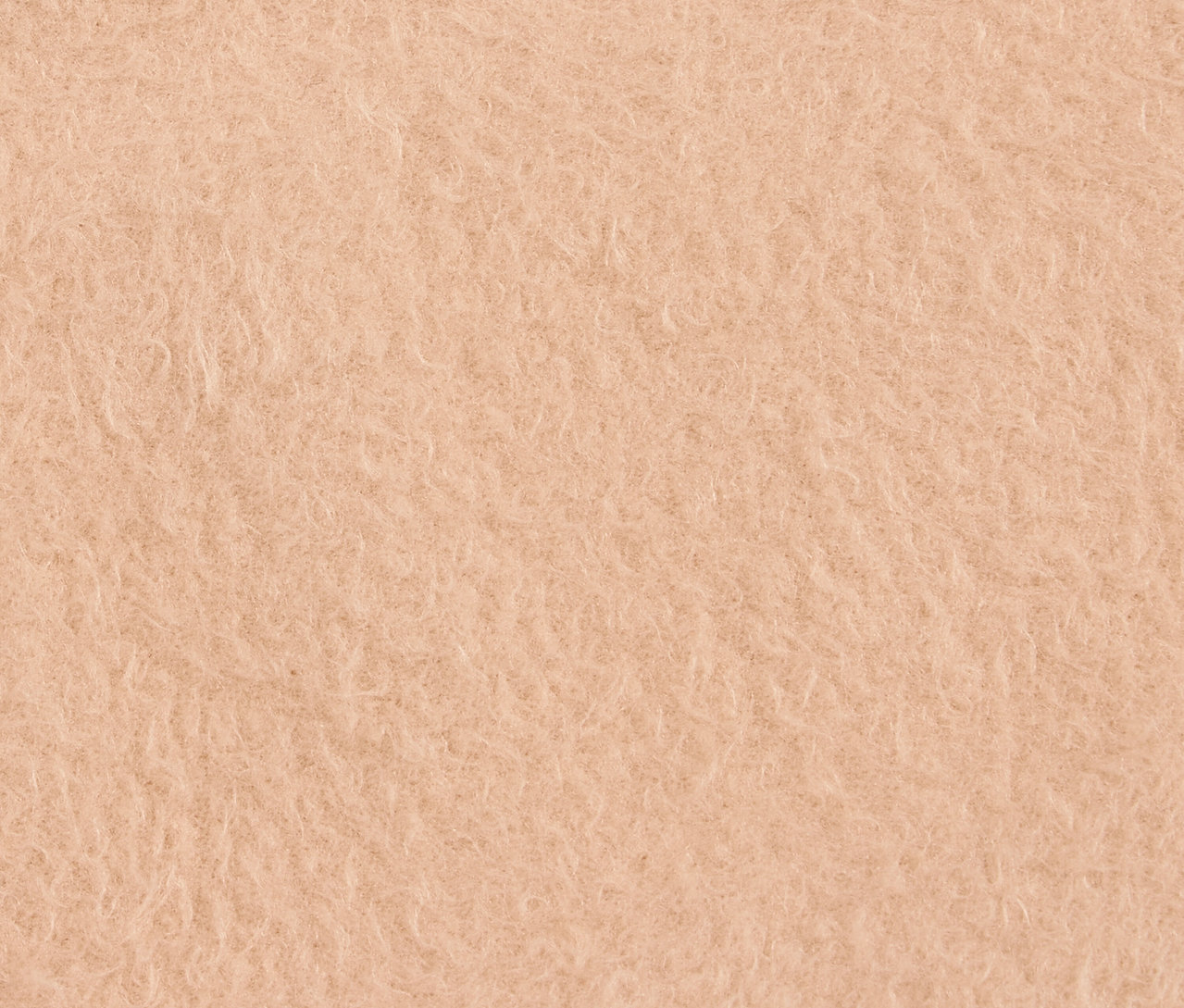 Közeli kép egy barack színű, bolyhos textúráról.