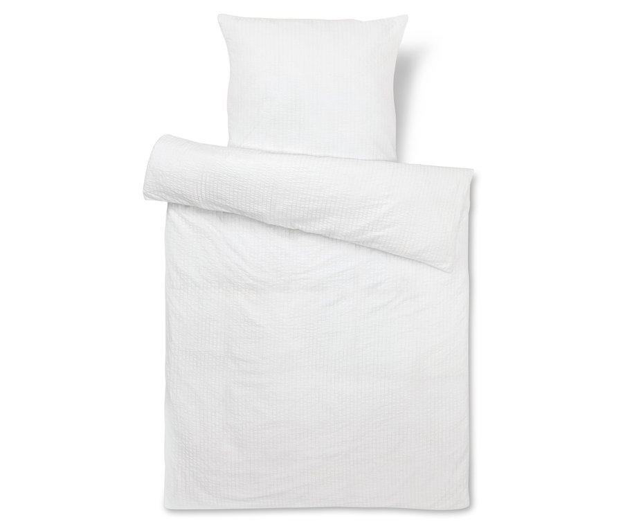 Fehér ágynemű garnitúra párnával.