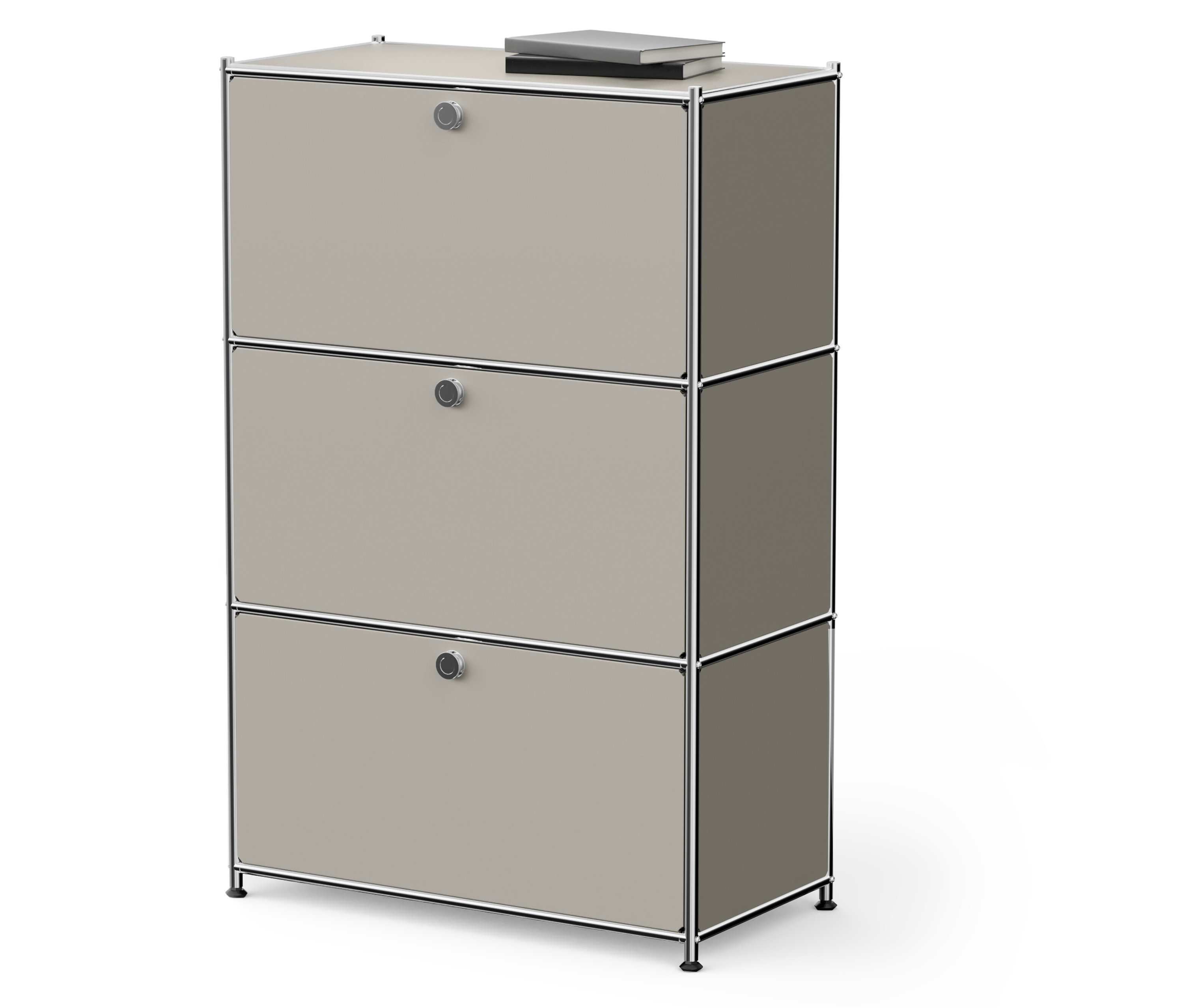 Háromszintes bézs szekrény, tetején egy könyvvel.