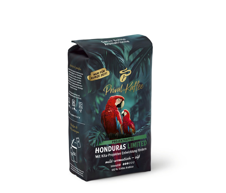 Sötét Privat Kaffee Limited Edition Honduras kávécsomag trópusi levelekkel és két vörös arával, „Ganze Bohne” felirattal.