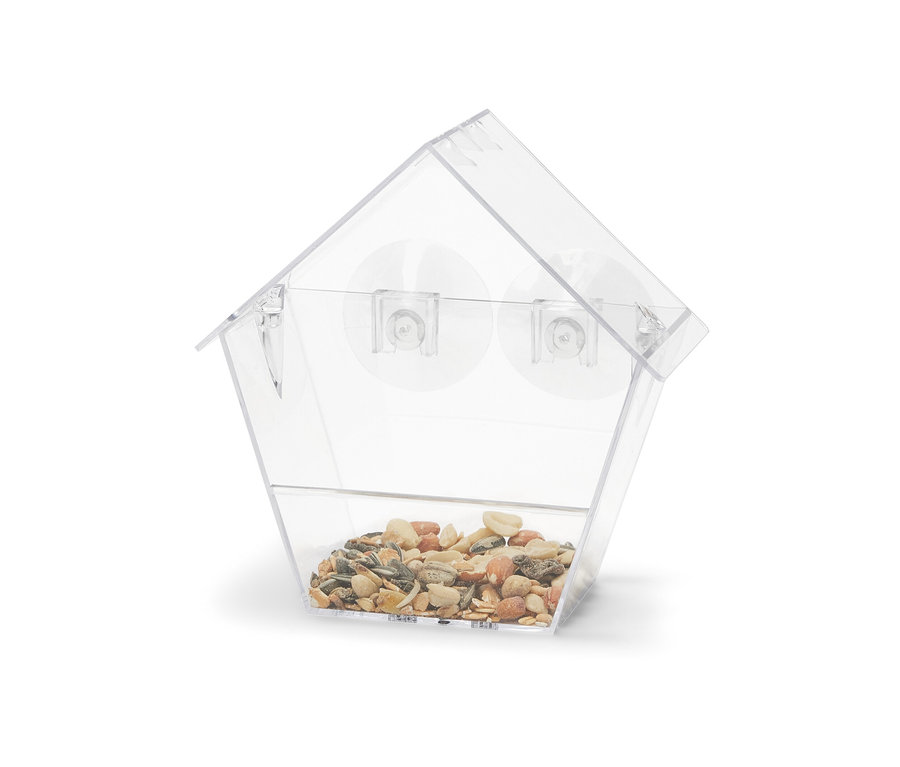 Egy átlátszó Madárház ablakra, tele magokkal.