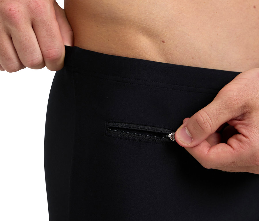 Férfi cipzározza ki egy fekete nadrág cipzárját.