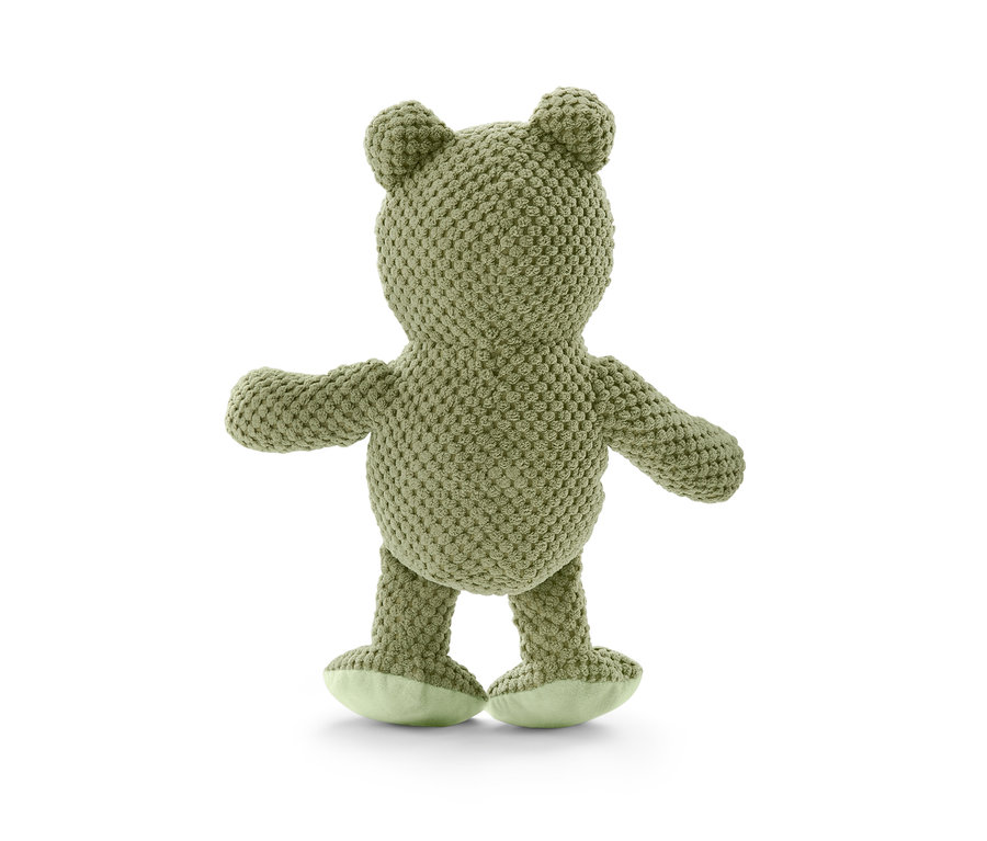 A plüss kutyajáték, béka egy fehér háttéren áll.