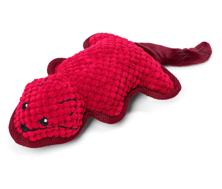 Egy piros, állat alakú plüssjáték fekszik egy fehér háttéren.