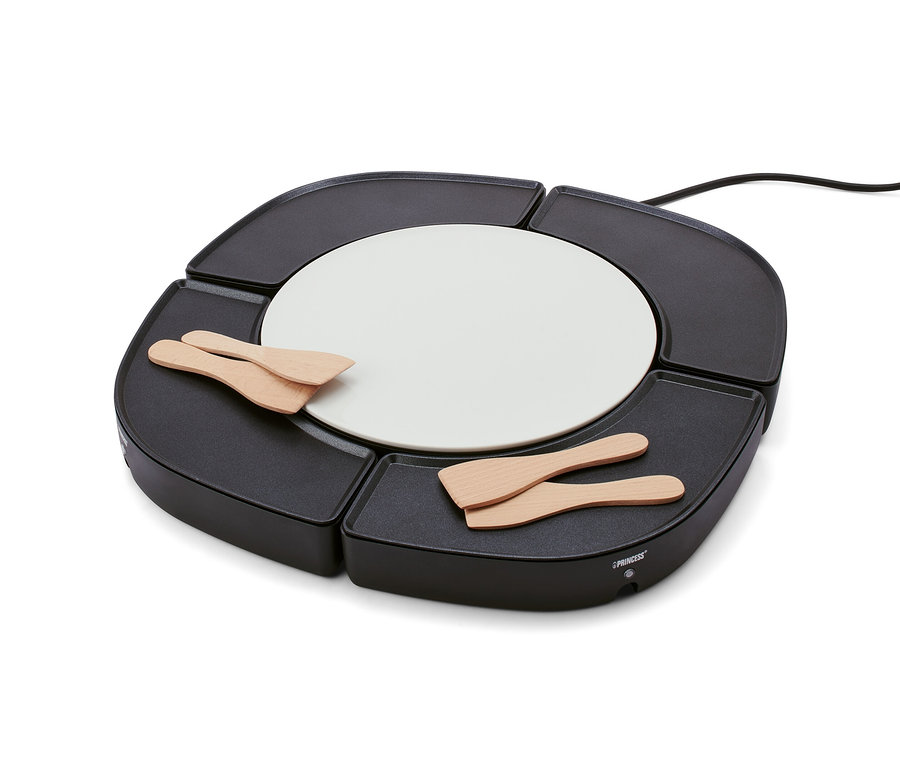 Fekete »Dinner4All« asztali grill fehér, kerek középpel és négy fa spatulával.
