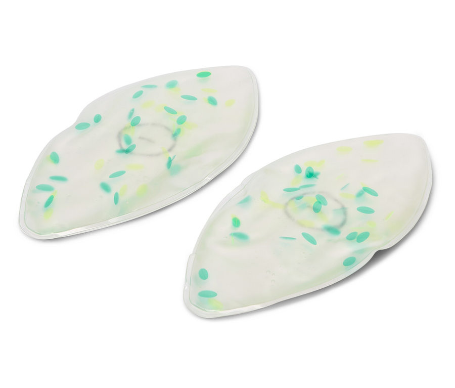 Két fehér gél szemmaszk zöld és sárga pöttyökkel fekszik egy fehér háttéren.