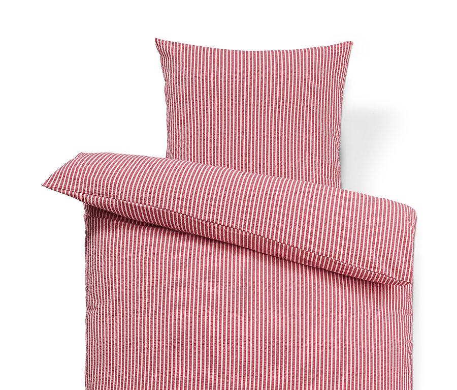 Felülnézet egy piros-fehér csíkos, normál méretű krepp ágyneműről.