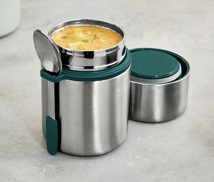 Egy rozsdamentes acél ételhordó termosz kanállal, leves van benne.